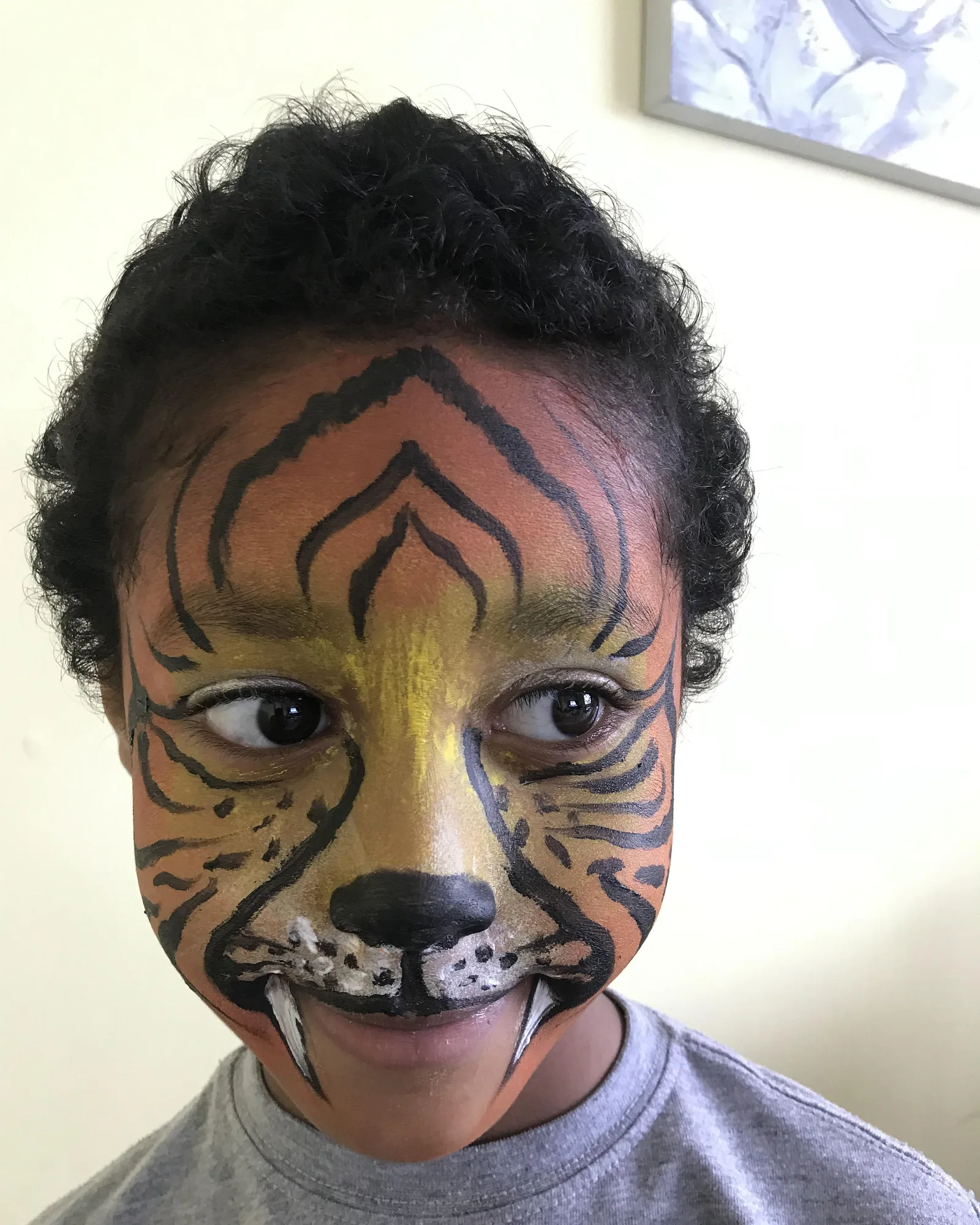 Piya's tiger face-painting design with fangs, front on